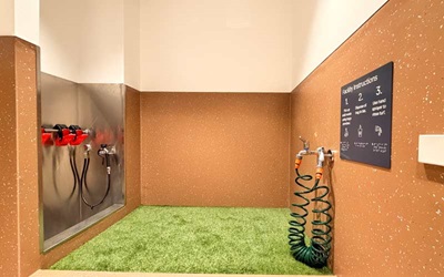 Service Animal Relief Area with a patch of grass and hoses.