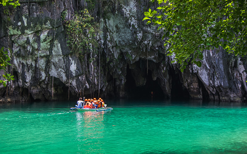 Boat of tourists entering Puerto Princesa Underground River caves