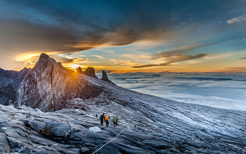 Hikers climb Mount Kinabalu, the highest peak in Malaysia