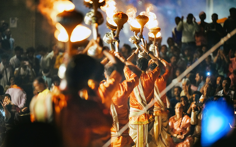Men performing evening Diwali ceremony in front of crowd