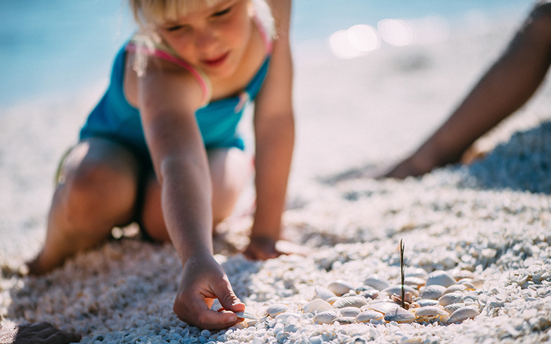 Child reaching for shell at Shell Beach, Western Australia