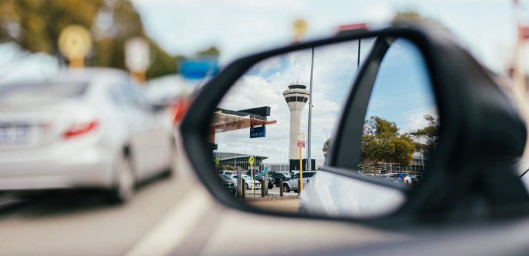 Image of a car rearview mirror with the tower in reflection
